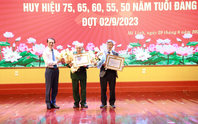 Đ/c Hoàng Trọng Quyết - Ủy viên Ban Thường vụ, Chủ nhiệm Ủy ban Kiểm tra Thành ủy Hà Nội trao Huy hiệu 75 năm tuổi Đảng cho các đảng viên. 